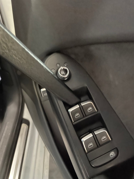 Slim vacuum crevice tool cleaning the gap around car door window switches and trim